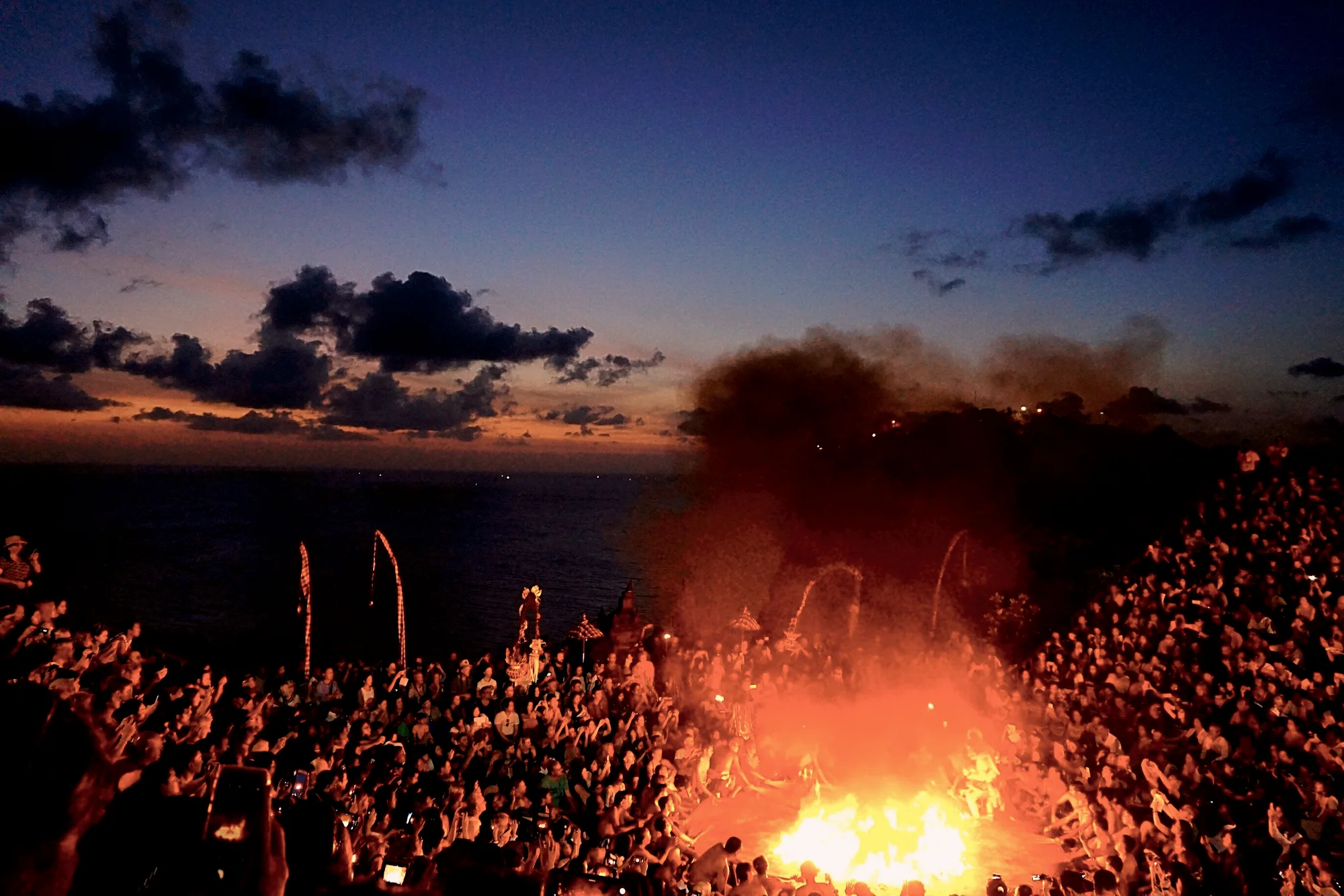 The Kecak fire dance at Uluwatu as the sun sets over the sea