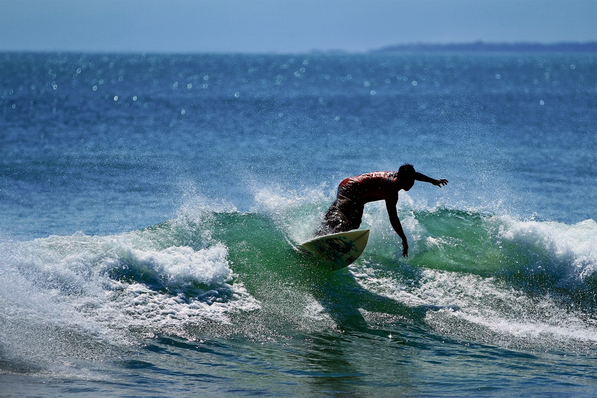 A surfer on a wave at Kuta