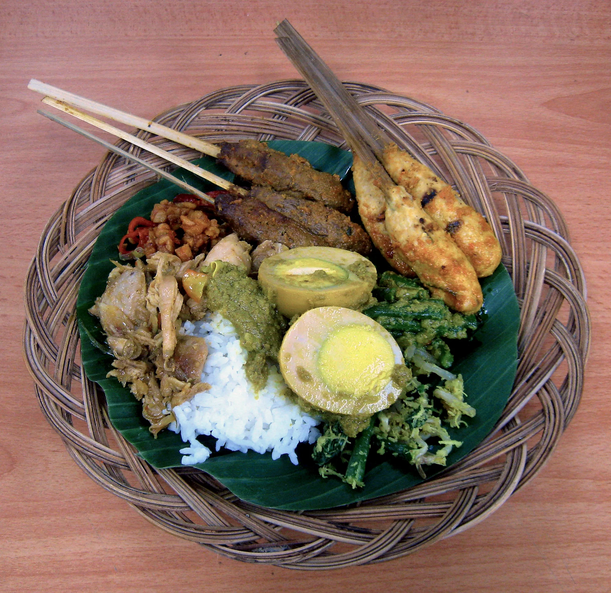 Nasi campur served on a banana leaf