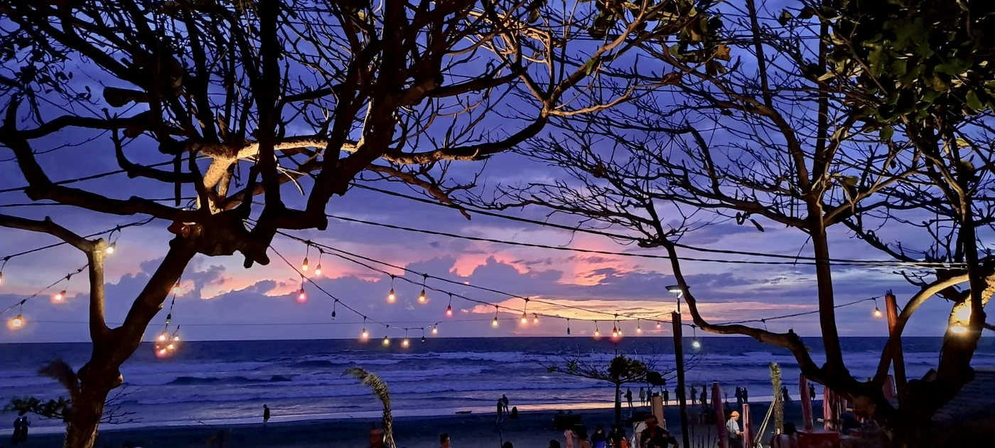 String lights in the trees on Seminyak beach at dusk