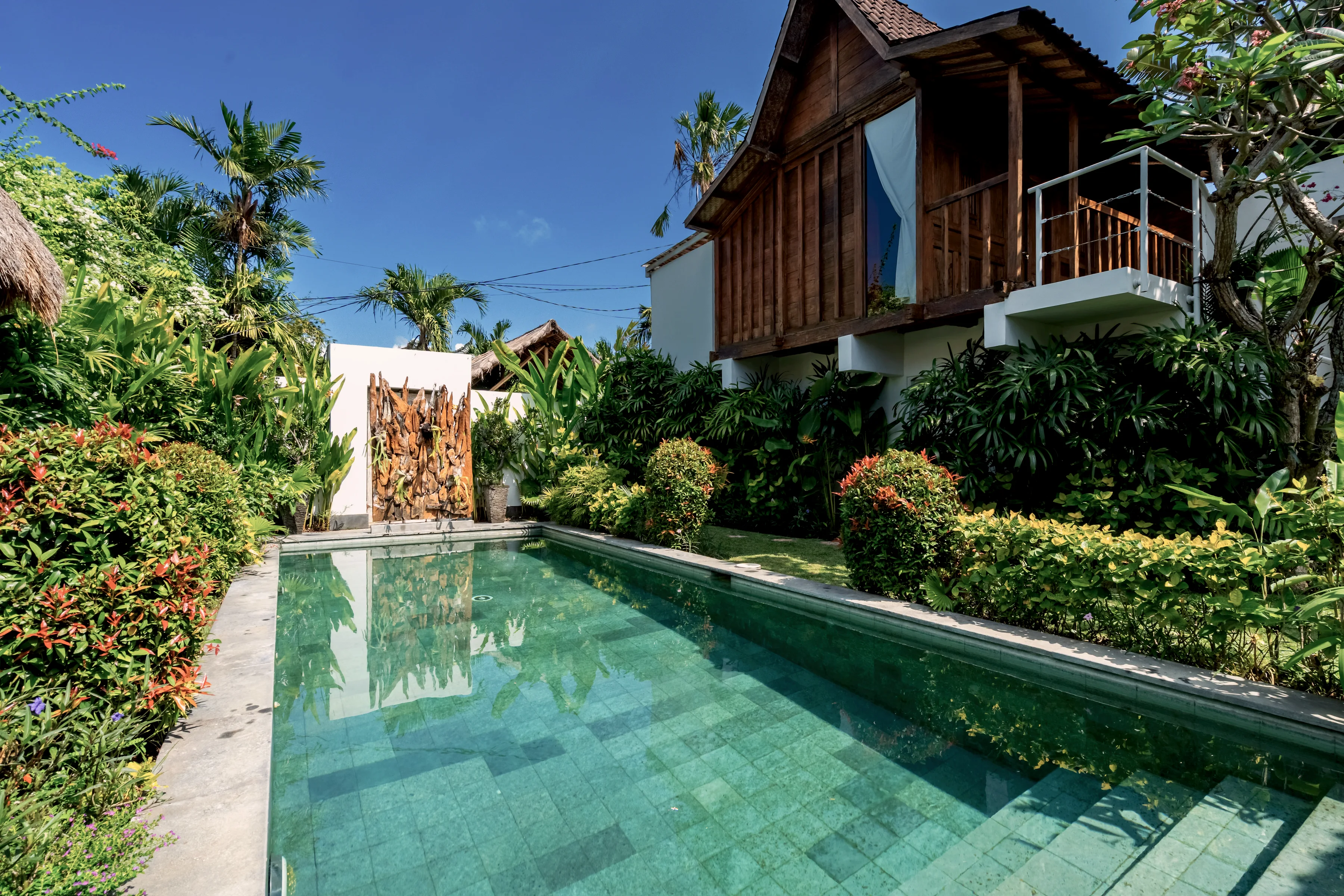 The pool from the corner, the Joglo’s upper balcony in the sun