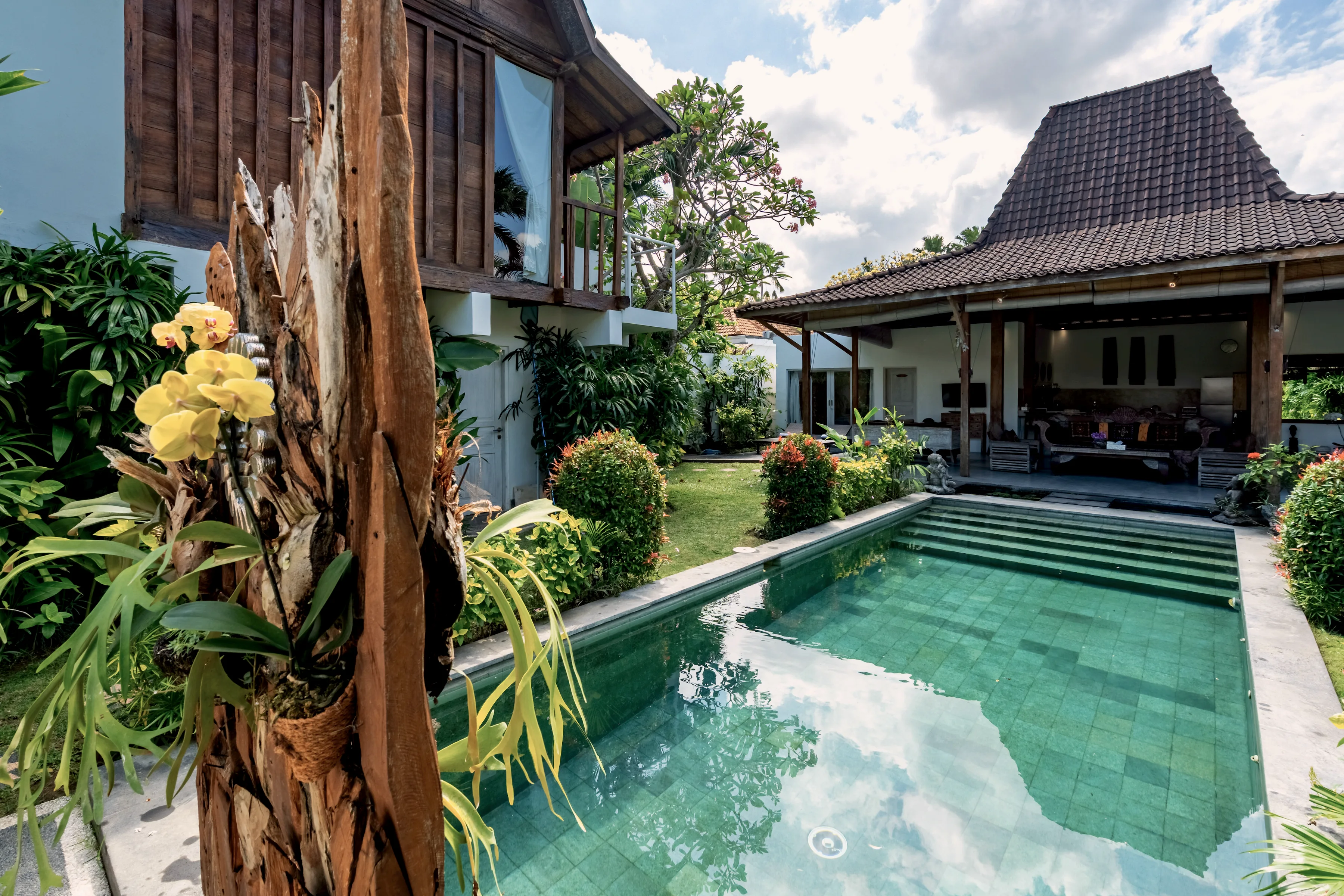 The pool framed by a weathered timber post