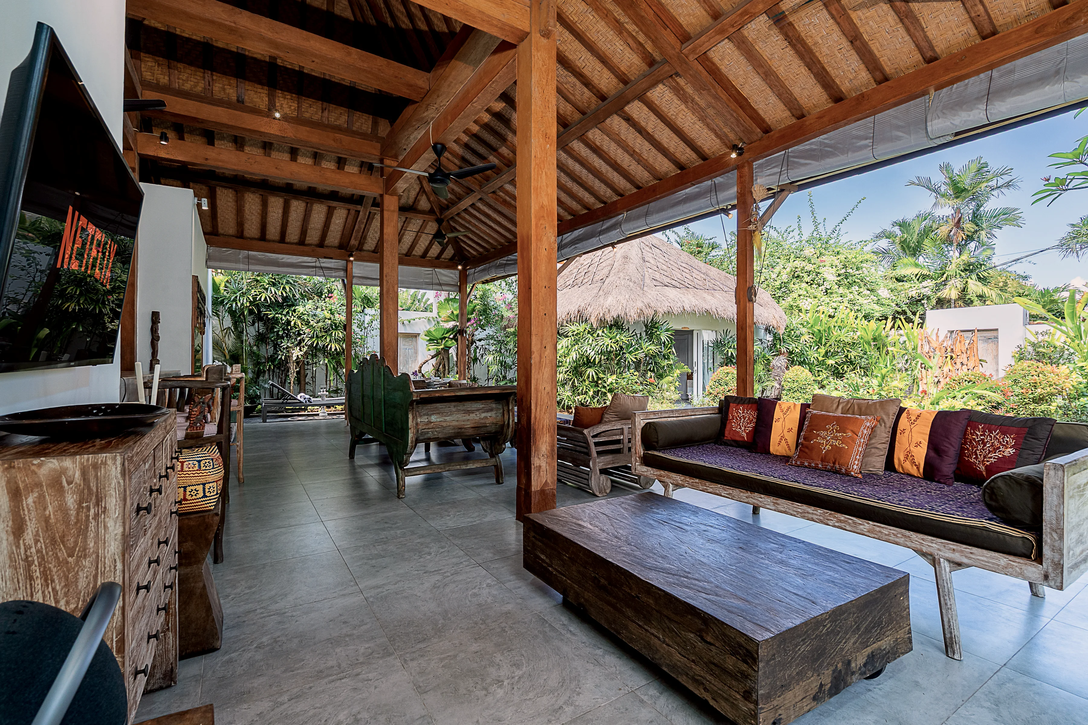 The open-sided lounge with daybeds and a carved cabinet